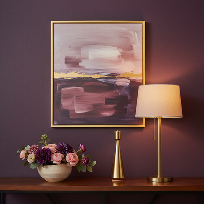 Gold-tone tapered candle holder on a colorful entryway console beside a ceramic bowl and flowers