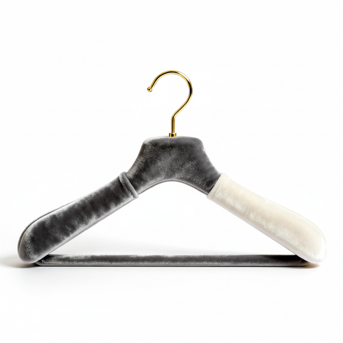 Dual-tone velvet clothes hanger with sculpted shoulders and gold curved hook on a white background