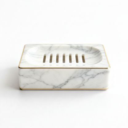 White marble-look draining soap dish with gold trim on a white background