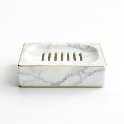 White marble-look draining soap dish with gold trim on a white background