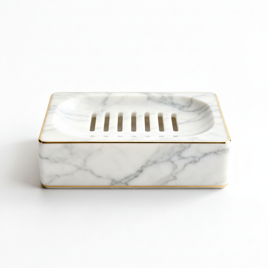 White marble-look draining soap dish with gold trim on a white background